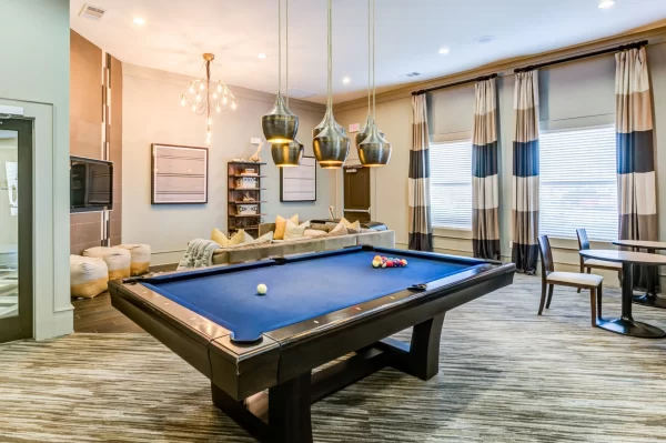 Billiards lounge with pool table, couch, table seating, and a television